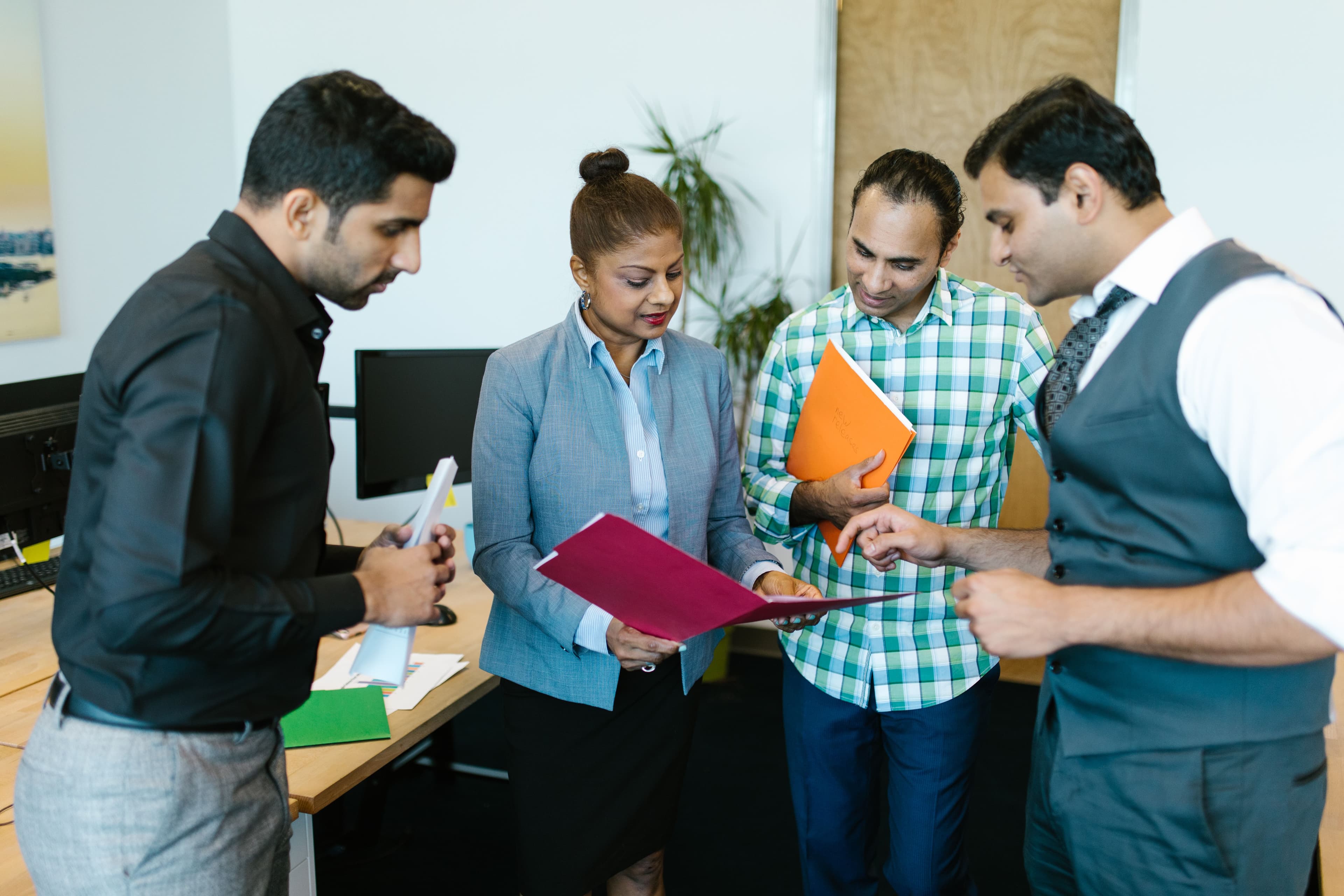 Legal professionals reviewing and signing trademark documents